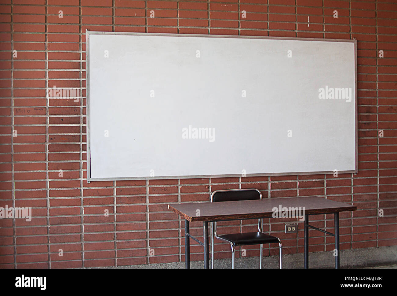 Empty Teacher`s Desk With Whiteboard In The Background No Teacher No